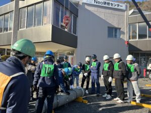 玉掛け技能講習の実技で合図を確認しながら作業に取り組む実習生の様子